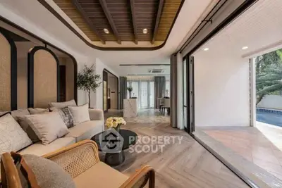 Luxurious open-plan living room with pool view and elegant decor