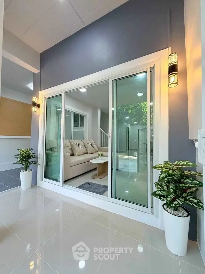 Modern living room with sliding glass doors and elegant lighting