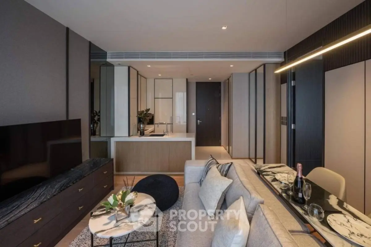 Modern living room with sleek design and open kitchen layout, featuring stylish furniture and decor.