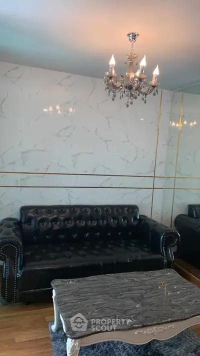 Luxurious living room with elegant chandelier and marble accents