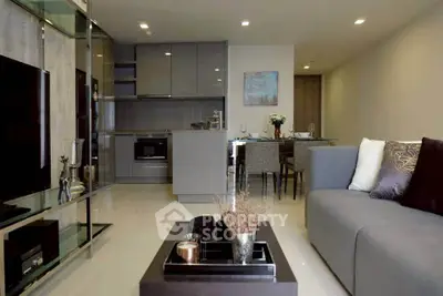 Modern living room with open kitchen, sleek furniture, and elegant decor in a stylish apartment.