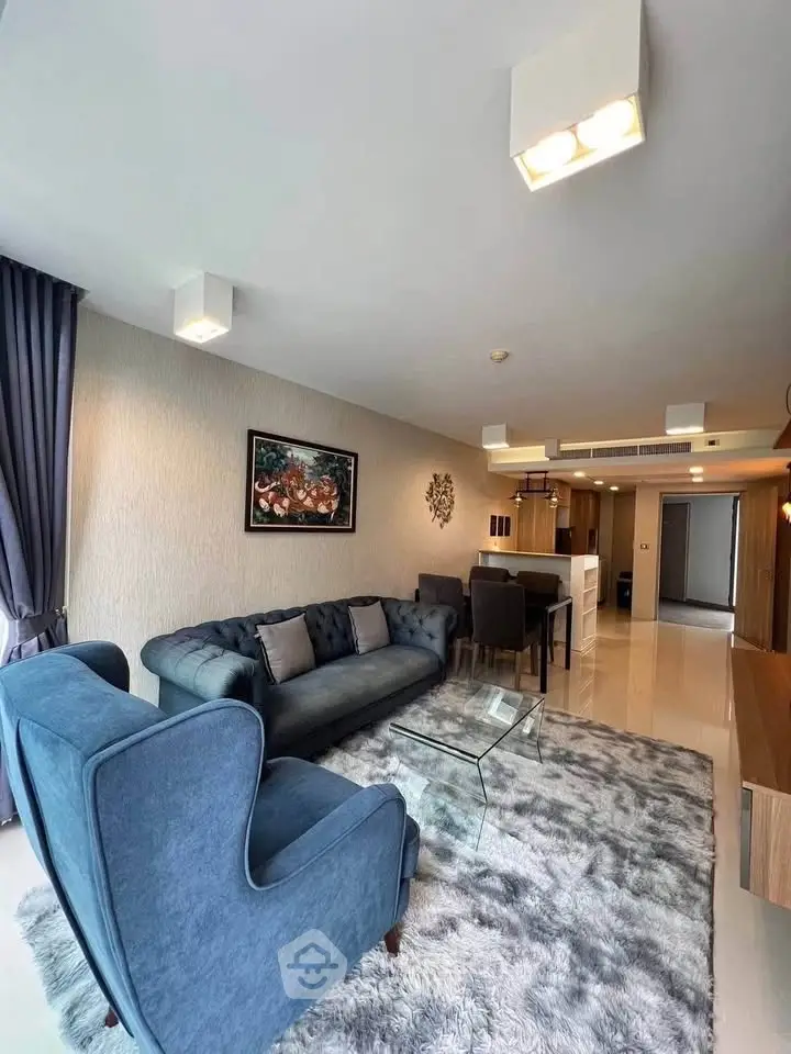 Spacious modern living room with elegant furniture and open layout in a luxury apartment.
