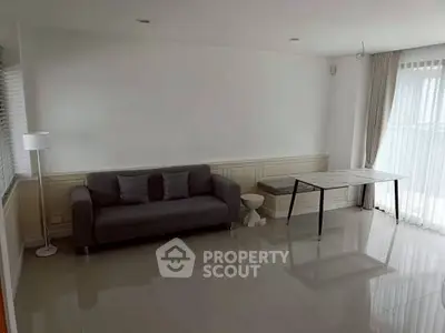 Spacious minimalist living room with modern sofa and natural light