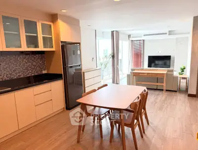 Spacious open-plan kitchen and living area with modern furnishings and natural light.