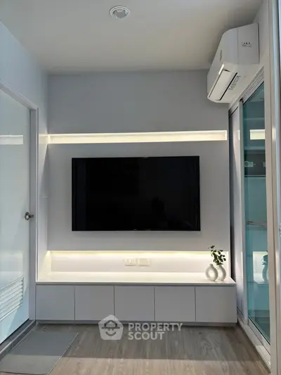 Modern living room with sleek TV setup and ambient lighting