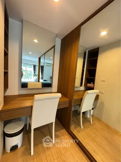 Stylish bedroom with mirrored wardrobe and elegant vanity area