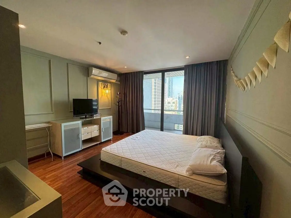 Spacious bedroom with city view and modern decor in high-rise apartment