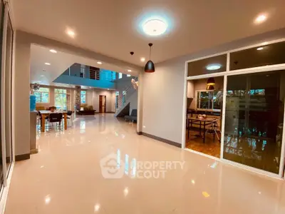 Spacious modern living room with open layout and elegant lighting