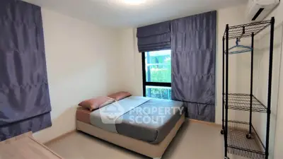 Cozy bedroom with modern decor and ample natural light, featuring a comfortable bed and stylish curtains.