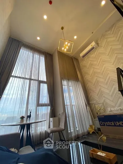 Luxurious high-ceiling living room with modern decor and large windows offering stunning views.