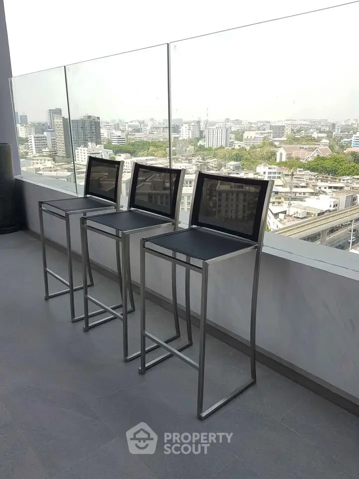 Stunning rooftop view with modern bar stools overlooking city skyline