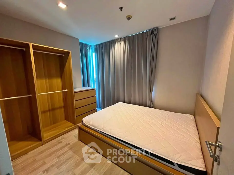Spacious bedroom with wooden furniture and ample natural light