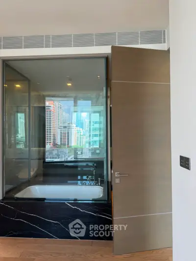Luxurious bathroom with city view and modern bathtub in high-rise apartment
