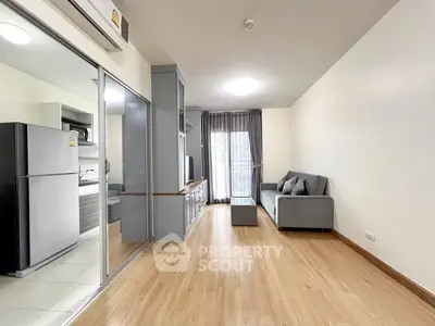 Modern living room with wooden flooring and sleek furniture in a stylish apartment.