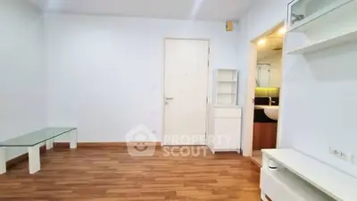 Spacious living room with wooden flooring and modern minimalist furniture.