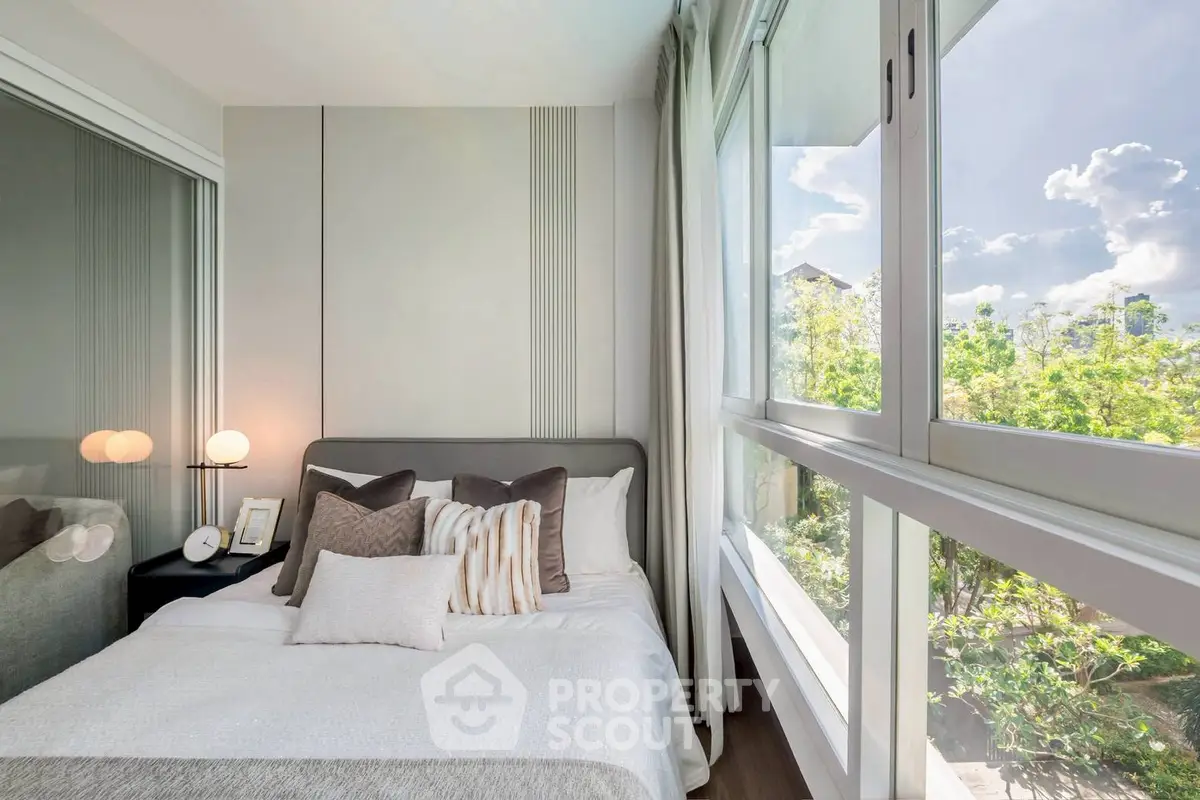 Bright and cozy bedroom with large windows and modern decor