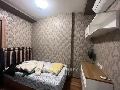 Cozy bedroom with stylish wallpaper and modern furnishings, perfect for a comfortable living experience.