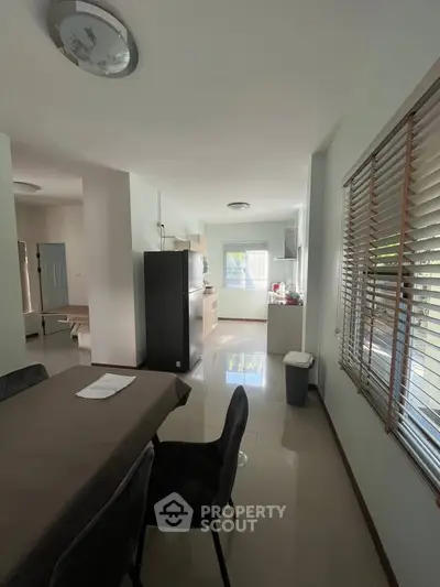 Spacious open-layout kitchen with dining area and modern appliances.