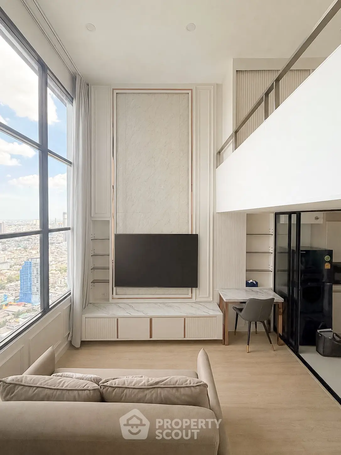Luxurious high-rise living room with stunning city view and modern interior design.