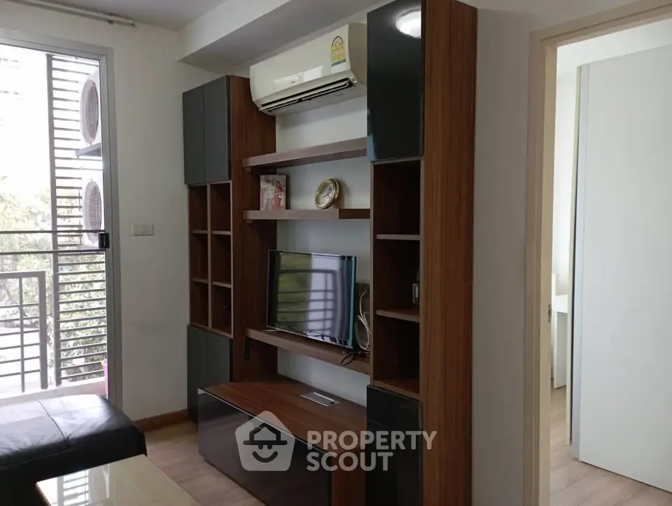 Modern living room with sleek wooden shelving and balcony view