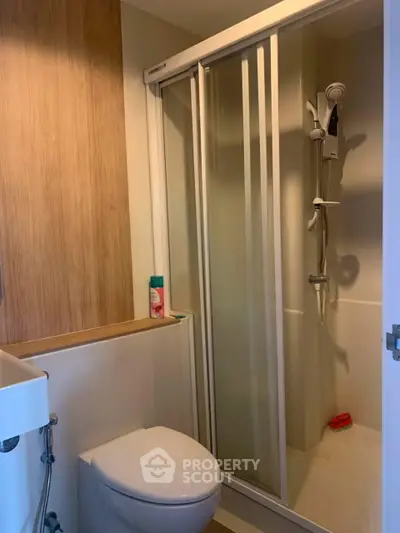 Compact modern bathroom with shower cabin and sleek fixtures