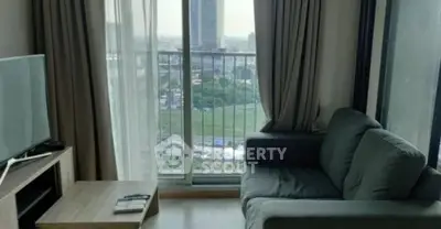 Modern living room with city view and cozy seating area.