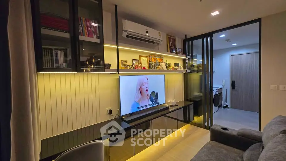 Modern living room with sleek TV setup and cozy seating area