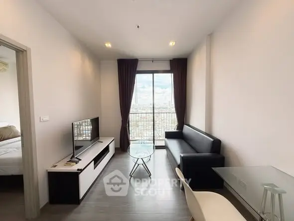 Modern living room with sleek furniture and city view from balcony.