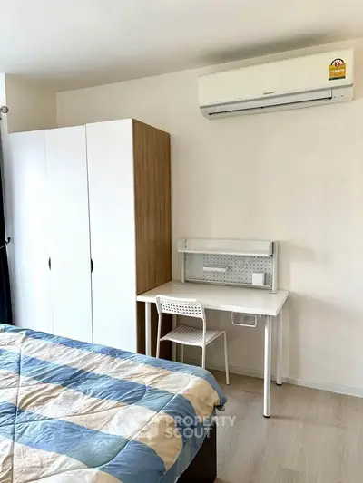 Modern bedroom with air conditioning and stylish furniture, perfect for comfortable living.