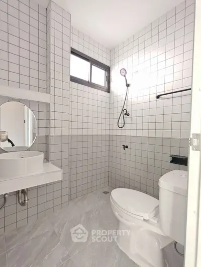 Modern bathroom with sleek white tiles and contemporary fixtures
