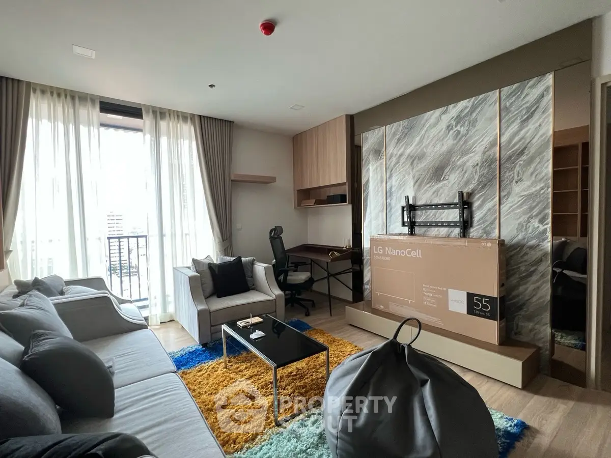 Modern living room with stylish decor and large window for natural light.