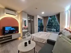 Modern studio apartment with stylish decor and large windows for natural light.