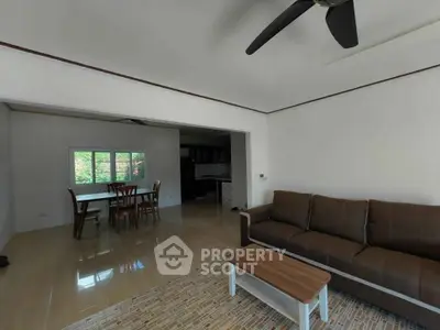 Spacious living room with modern furniture and open dining area
