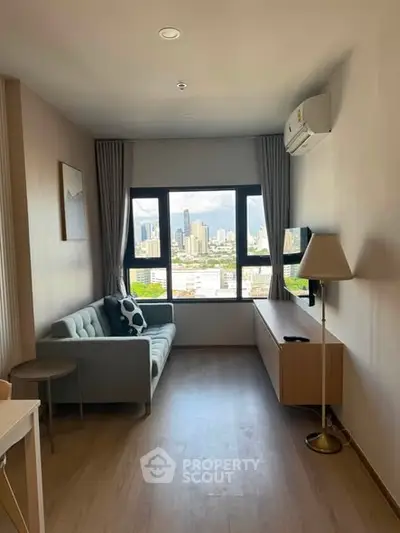 Modern living room with city view, featuring a cozy sofa and sleek decor, perfect for urban living.