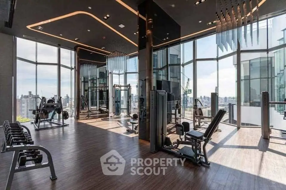 Luxurious high-rise gym with panoramic city views and modern fitness equipment.