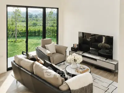 Luxurious living room with modern furniture and large windows overlooking a lush garden.
