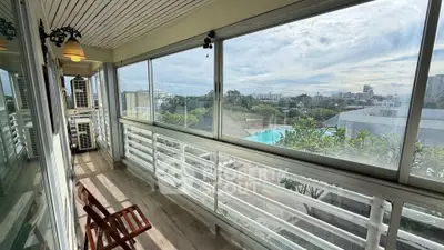 Spacious balcony with panoramic city view and pool, perfect for relaxation and enjoying the outdoors.