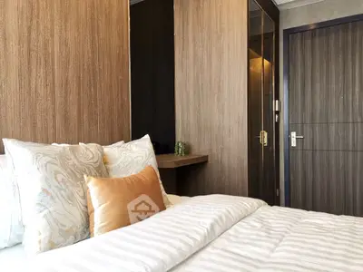 Luxurious bedroom with elegant decor and cozy bedding in modern apartment.