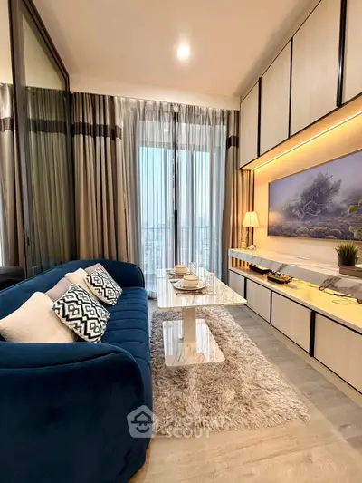 Luxurious living room with elegant decor and stunning city view, featuring plush blue sofa and modern furnishings.