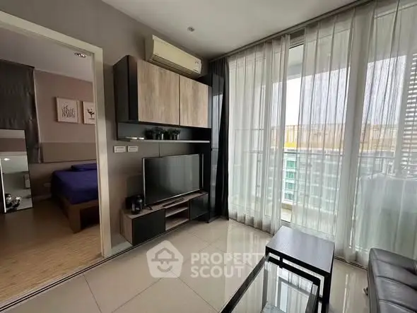 Modern living room with sleek furniture and large windows offering city views