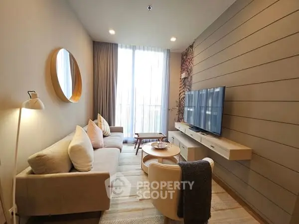 Modern living room with cozy seating and large TV, perfect for relaxation.