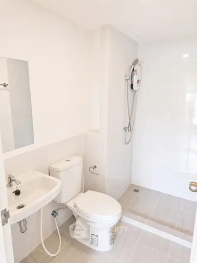 Modern bathroom with sleek fixtures and walk-in shower in a bright apartment.