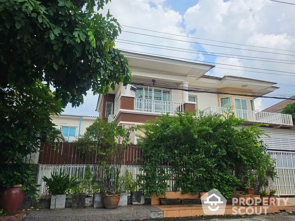 Charming two-story house with lush garden and spacious balcony in serene neighborhood.