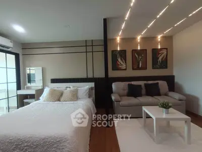 Modern studio apartment with stylish decor and cozy seating area.