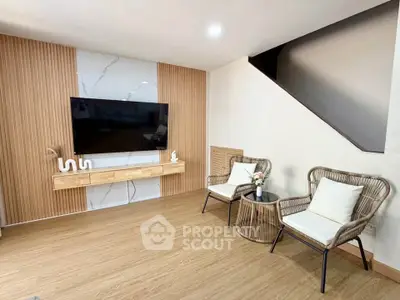 Modern living room with stylish wooden paneling and cozy seating area
