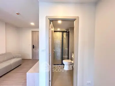 Modern apartment interior with cozy living room and sleek bathroom design.