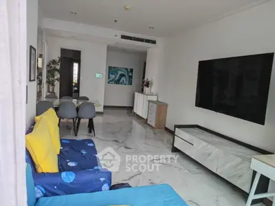 Spacious modern living room with marble flooring and large TV