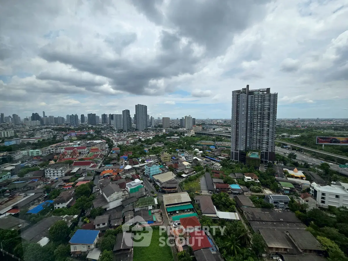 Stunning cityscape view from high-rise building showcasing urban skyline and residential area.