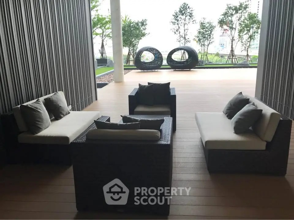 Stylish outdoor seating area with modern furniture and lush greenery, perfect for relaxation and social gatherings.