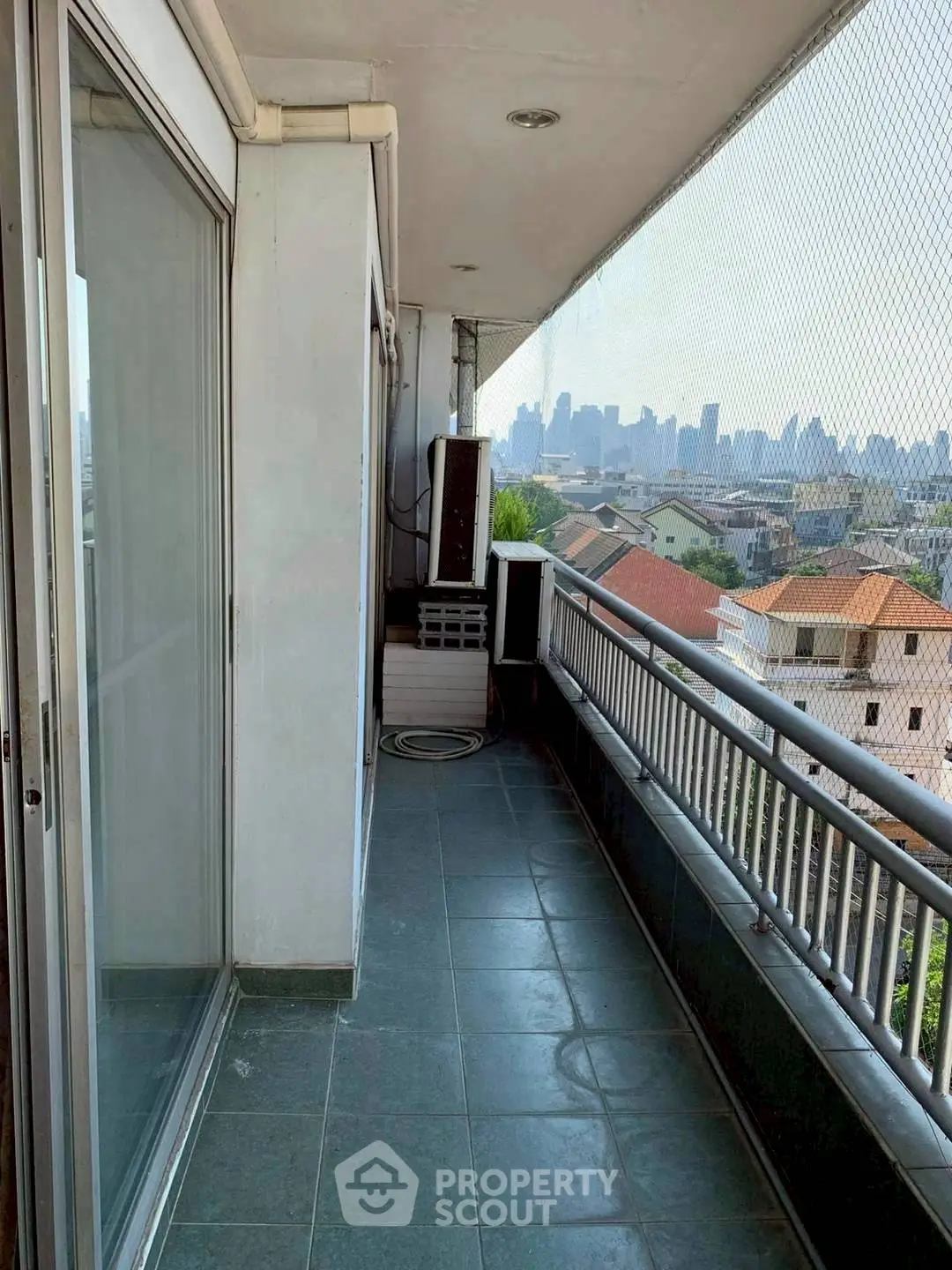 Spacious balcony with city skyline view, perfect for relaxation and enjoying urban scenery.